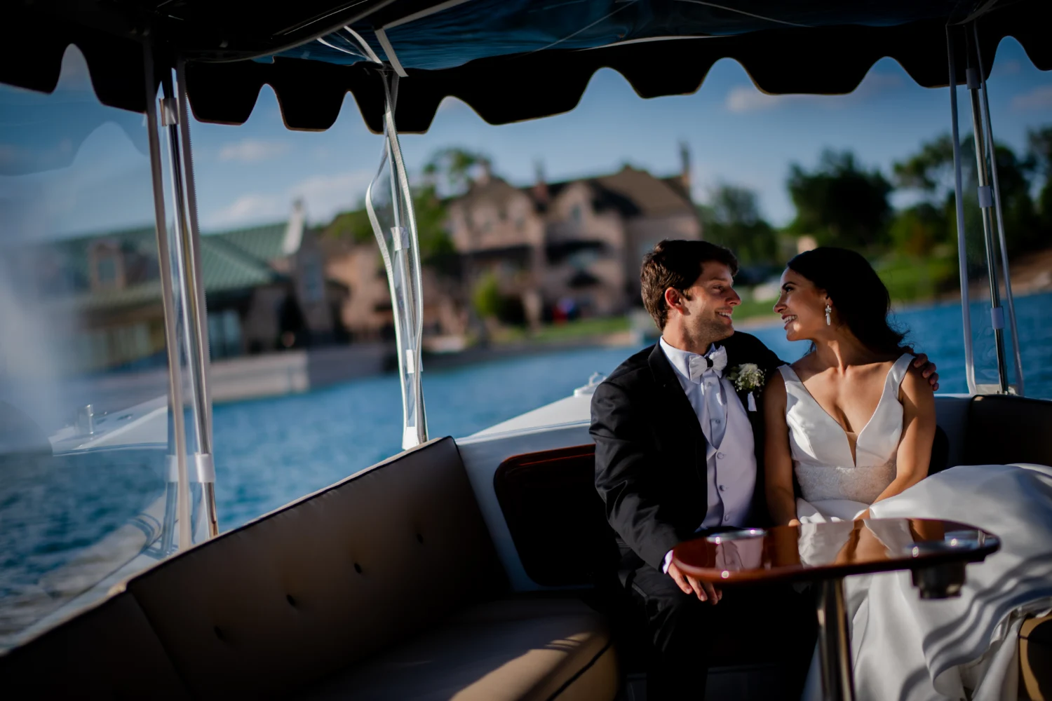 Smiling couple on pontoon boat on The Red Berry Estate Lake