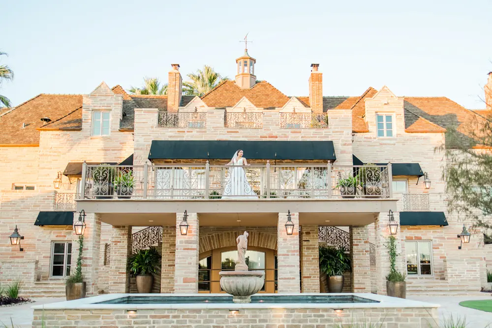 Bride standing on the Lakeview Terrace of the Red Berry Mansion.