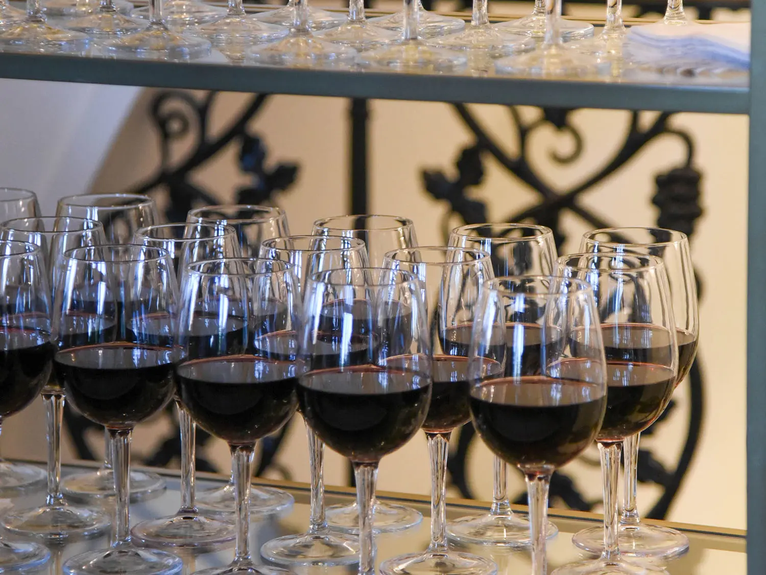 Wine glasses full of red wine on counter ready to be served at The Red Berry Estate