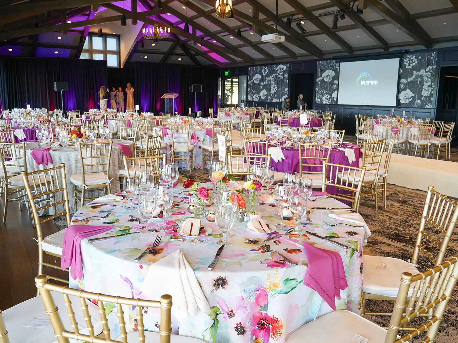 An expansive banquet room filled with tables and chairs, set up for a large event or dining occasion.