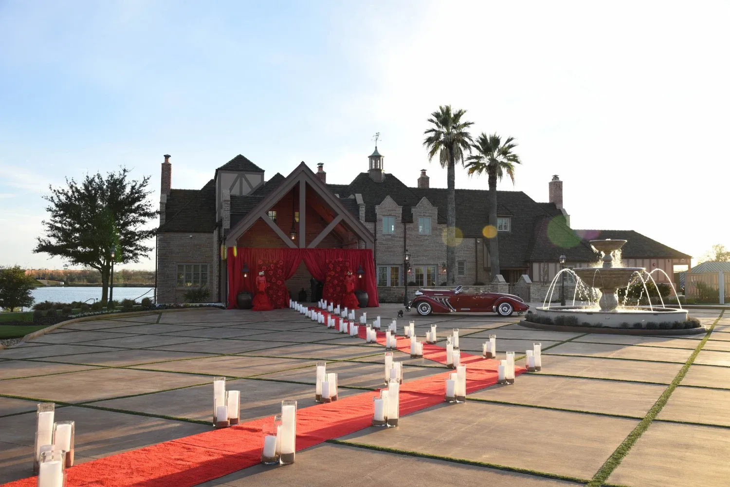 Red carpet lined with candles leading tot he entrance of The Red Berry Estate