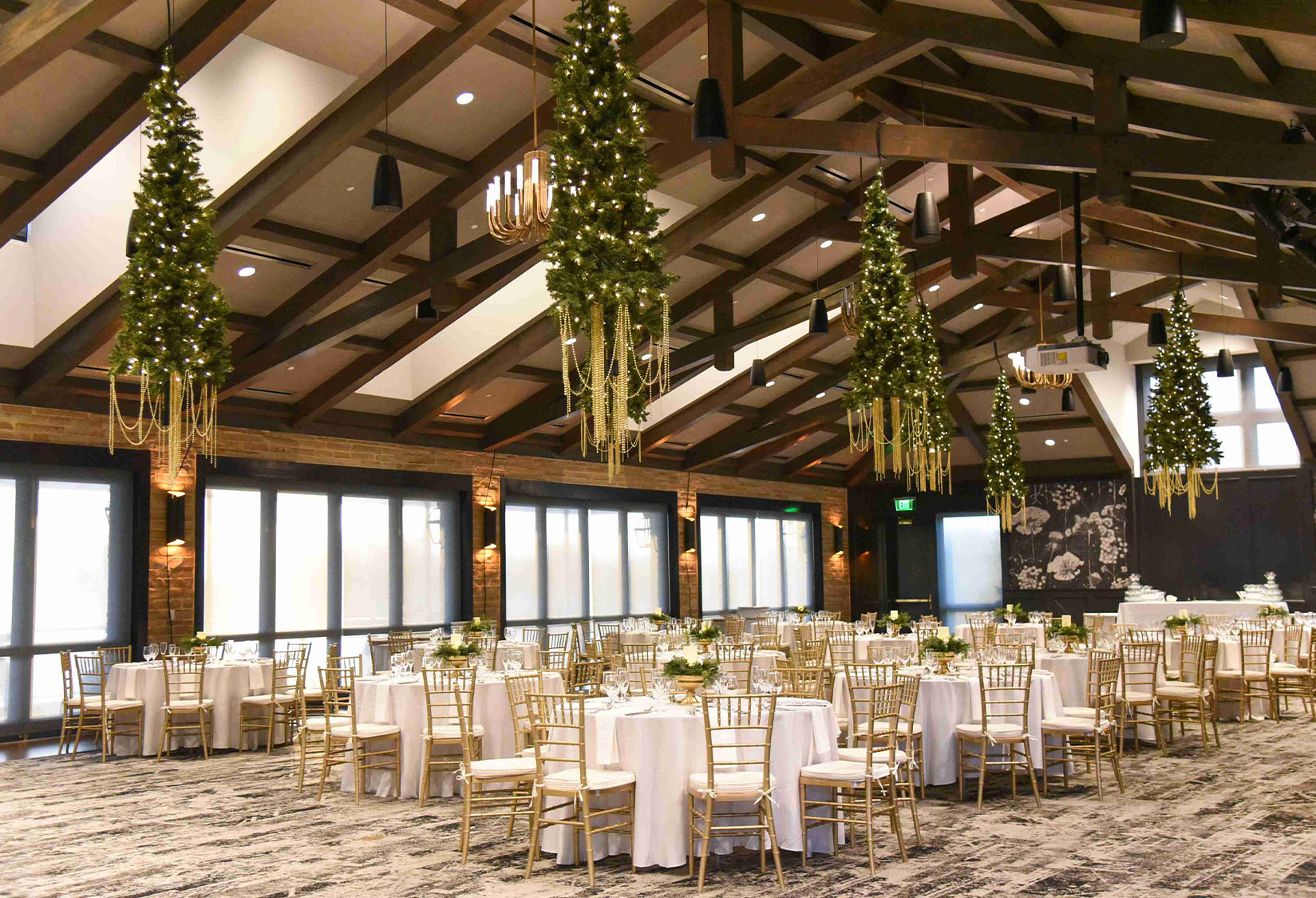 Ballroom with christmas trees hanging from the ceiling