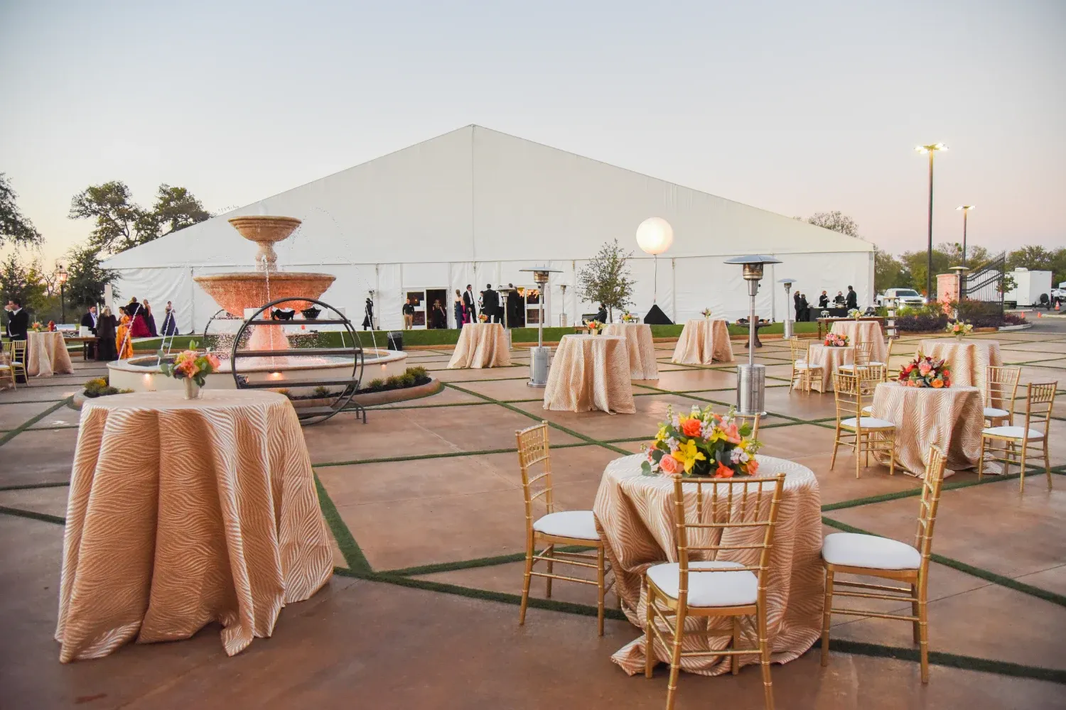 Tables set up in front of a large white tent on The Red Berry Estate lawn
