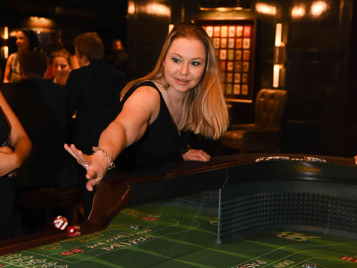 woman throwing dice at craps table