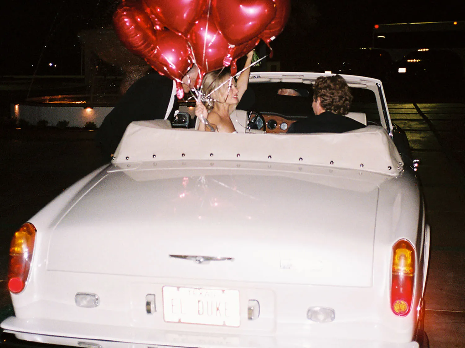 Old White car with balloons, getaway car for newly wed couple